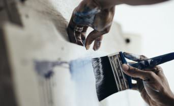 Hands painting on a canvas