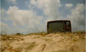 Television stuck in a sand dune