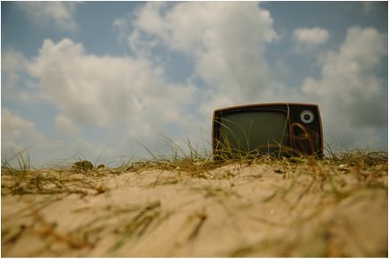 Television stuck in a sand dune