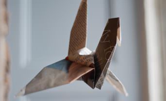 Newspaper article folded into a paper crane