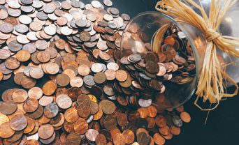 Coins spill out of a glass jar