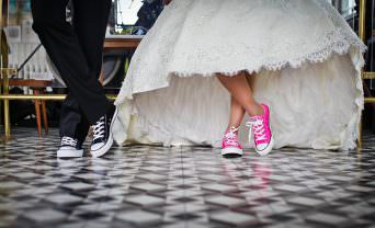 Bride and groom wear casual shoes with formal dress