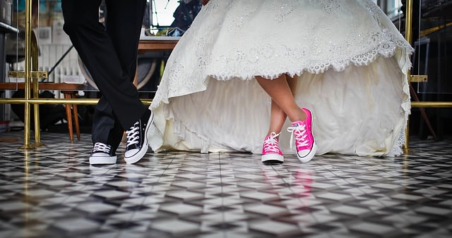 Bride and groom wear casual shoes with formal dress